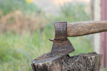 Old axe.Rusty axe for chopping firewood close-up.Countryside, village.