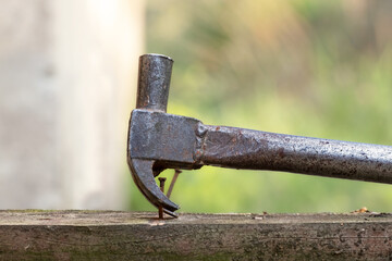 Old rusty nail puller. Small carpentry work in the workshop. Home renovation.