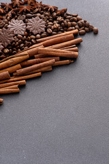 Food background. Coffee beans, cinnamon sticks and chocolate candies top view. Copy space