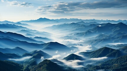 A rolling mountain range in the early morning mist, the peaks emerging and disappearing as the fog s - obrazy, fototapety, plakaty