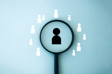 Human resources management concept. Employment headhunting. Recruiting with online technology. Magnifying glass focuses on manager icon, best candidate. Searching human to join the  team 