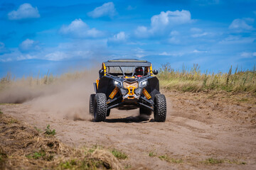 UTV buggy and 4x4 off road vehicle in sandy track. Buggy extreme riding