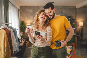 adult happy couple man and woman shopping online hold credit card