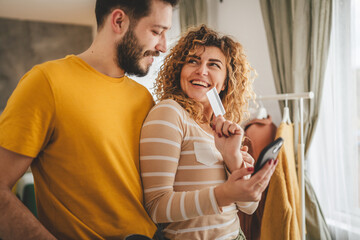 adult happy couple man and woman shopping online hold credit card