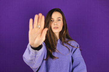 Brunette woman making hands stop action sign. I said, no. Angry frustrated young woman showing...