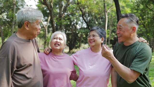 Group of elderly Asians exercising in outdoor park Meet and talk in a fun way. Health care in retirement. Elderly society. sports concept