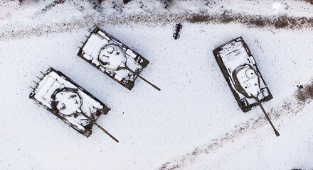 Snow-covered tanks in Poznań Citadel during winter, captured by drone.