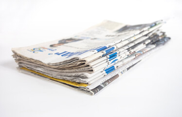 Pile of newspapers isolated on white background. Can be used for illustration or background design.