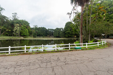 SÃO PAULO, SP, BRAZIL - FEBRUARY 03, 2024: Trail surrounding the lake of Alberto Lofgren State Park, better known as Horto Florestal (forest garden).