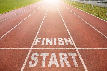 New beginnings concept. white starting line. word start and finish on a running track in a stadium. top view.