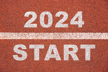 happy new year 2024 symbolizes the start of the new year. Rear view of a man preparing to run on the athletics track engraved with the year 2024. The goal of Success. Getting ready for the new year.