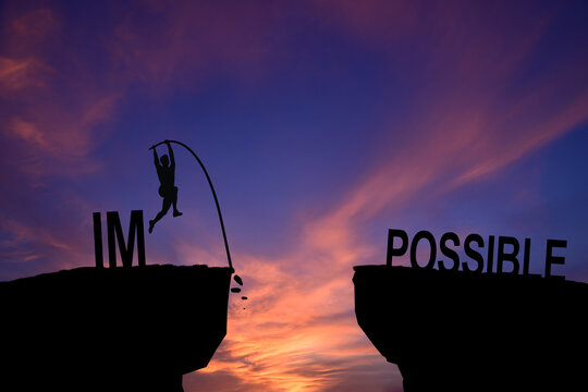 Mindset concept, Silhouette man jumping over impossible and possible wording on cliff with cloud sky and sunlight.