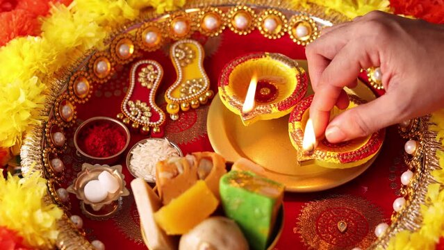 Onam Diwali vishu celebration Indian festival flowers marigold flowerbed lighted oil lamp Nilavilakku Diya colors Rangoli decoration greetings Dipavali Kerala Tamil nadu North India Mumbai Delhi India