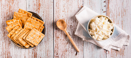 Fresh Italian mascarpone cheese in a bowl on the table top view web banner