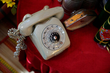 Top view of a vintage telephone on a table with red cloth