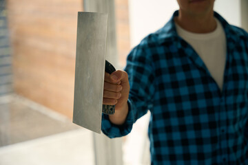 Cropped picture of workman hand holding float trowel