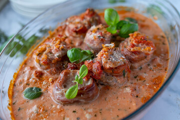 Pork tenderloin wrapped with italian parma ham in a delicious tomato cream sauce.