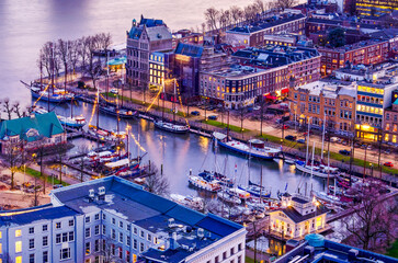Rotterdam, The Netherlands, February 12, 2024: aerial view of the Ferry Harbour marina during the blue hour after sunset - obrazy, fototapety, plakaty
