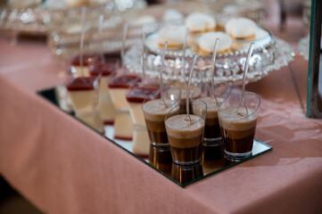 wedding mousse cakes on a candy bar on a gold stand