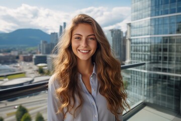 Fototapeta premium portrait of a young woman smiling with the city in the background