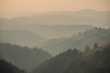View of distant mountains and hills at sunset