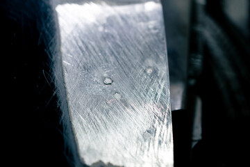 close-up of a part of the side panel near the wheel sanded to metal at service station