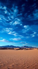 A vast expanse of sand dunes under a blue sky