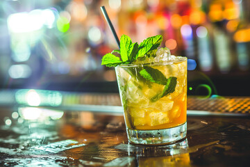 Mint Julep cocktail on a bar counter, traditional drink of the Kentucky Derby, fresh mint garnish, festive and refreshing atmosphere - obrazy, fototapety, plakaty