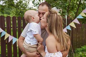 Fototapeta premium Joyful one-year-old boy's birthday celebration with his dear family members.