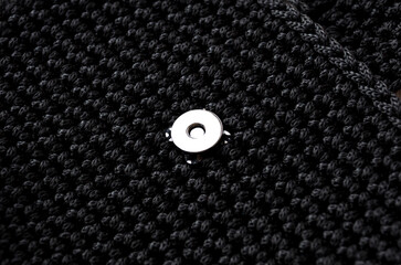 Black polyester cord bag. Episode of a bag with a magnetic clasp.
