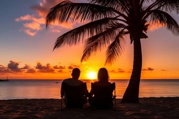 Zelfklevend Fotobehang Happy couple enjoying a romantic luxury sunset beach getaway during summer vacation © Daria