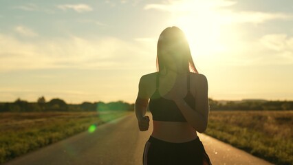 silhouette sports girl running along road sunset, summer thailand, healthy lifestyle, cardio wellness, athletics fitness, athlete exercise sunrise, woman running treadmill. healthy woman running - obrazy, fototapety, plakaty