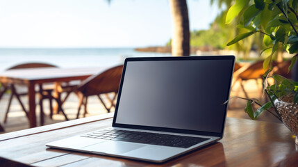 Laptop mockup on the table on the tropical ocean beach with palm trees and sand