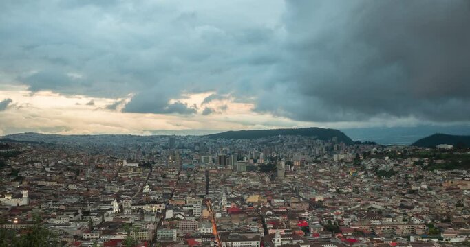 Timelapse of the city of Quito changing from afternoon to night with a cloudy sky in Ecuador