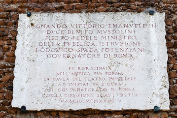 Commemorative Plaque in Ostia Antica Ruins Rome Italy Excavation of Ostia, ancient Roman port, next...
