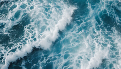 Fototapeta na wymiar aerial view of beautiful photo of blue water flowing in waves with white foam in a ocean. 