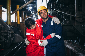 A female warehouse worker has an accident while working in a factory. .