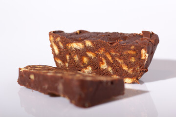 Chocolate salami dessert made from cocoa and broken biscuits. Isolated on a white background.