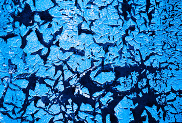 Cracked blue paint on the wall, background