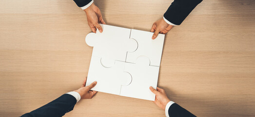 Top view panorama banner of business team assembling jigsaw puzzle over table symbolize business...