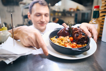Chef has prepared lamb shank with vegetables for serving