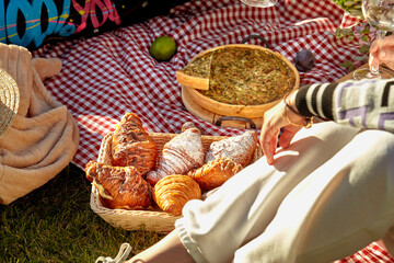 Cozy summer picnic with fresh pastries and quiche