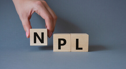 NPL - Non Performing Loan symbol. Concept word IPO on wooden cubes. Businessman hand. Beautiful...