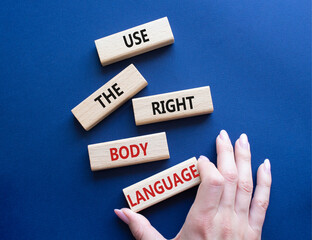 Use the right Body Language symbol. Concept words Use the right Body Language on wooden blocks. Businessman hand. Beautiful deep blue background. Business concept. Copy space