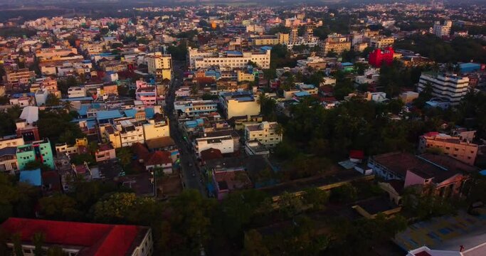 Aerial view above CSI Home Church and houses of Nagercoil town with streets at sunset in India