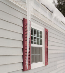 Fototapeta premium Large icicle hanging in front of house