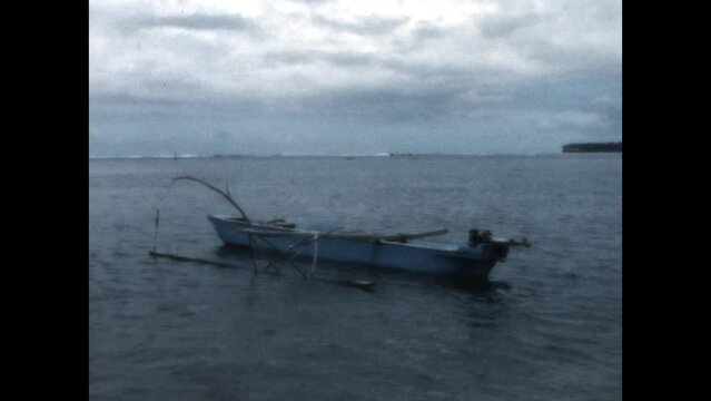 Makeshift Outrigger 1971 - A boat with a makeshift outrigger floats off shore in French Polynesia, 1971. 