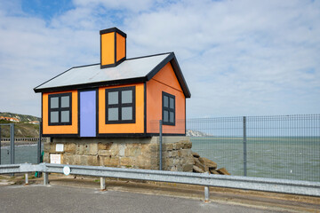 Fototapeta na wymiar Folkestone, Kent ,uk August 1, 2023 orange and black bungalow by Richard Woods on the harbour, in England