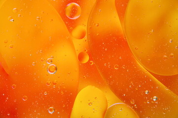 Abstract orange background, water mixed with oil, bubble and drops, macro