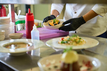 Cook decorates ready-made dishes for serving